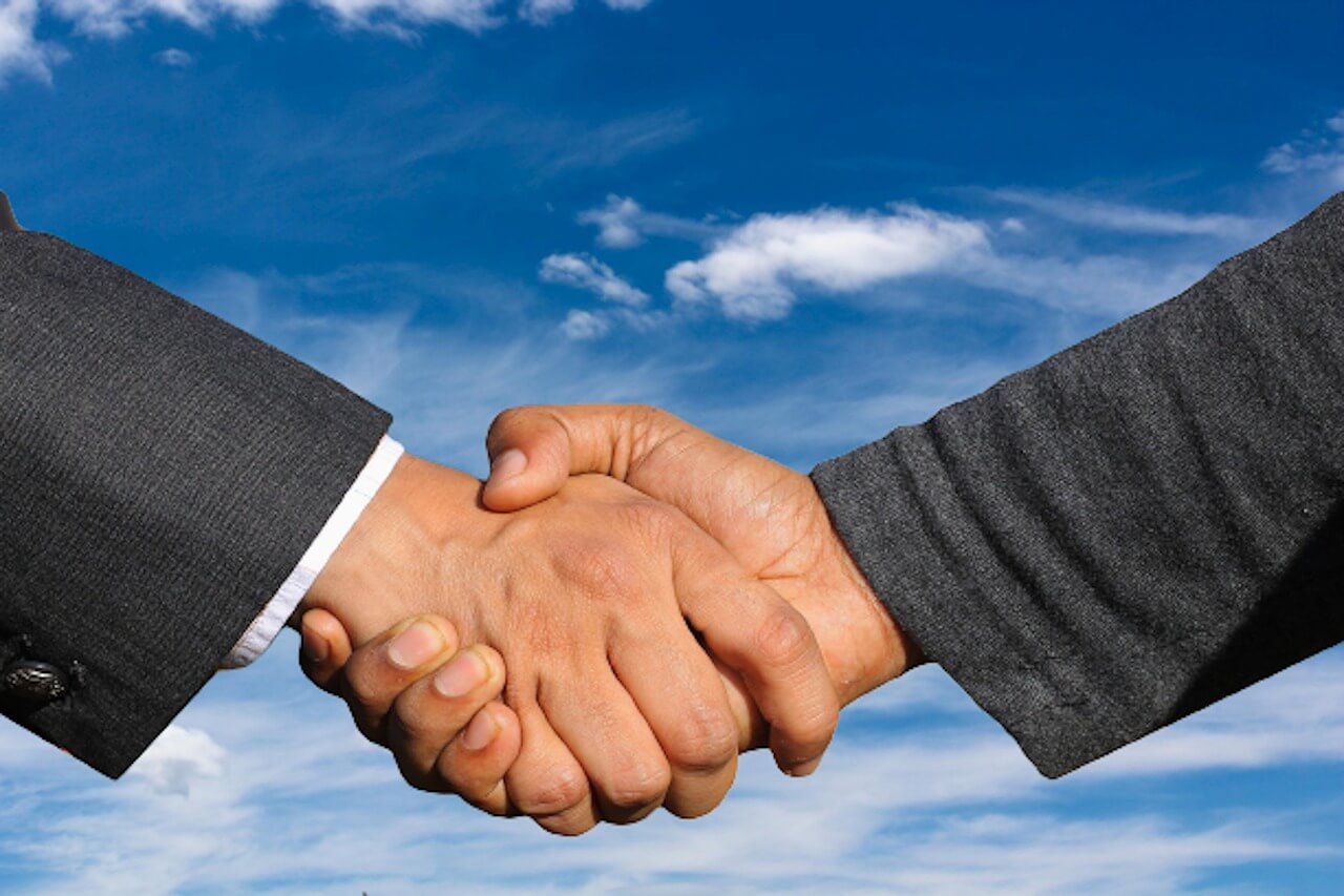 Close-up of businessmen shaking hands.