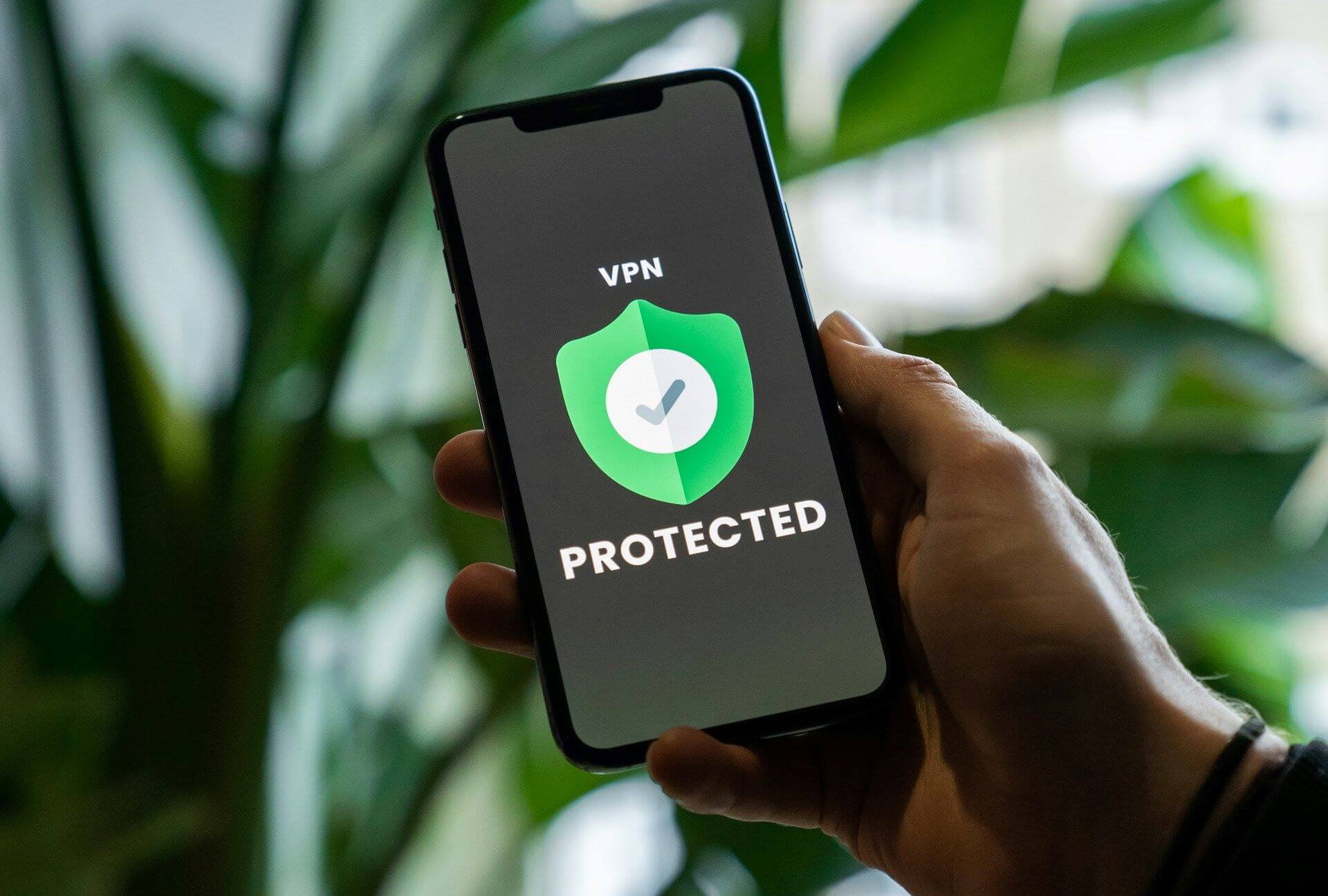 Image of personal information protection: A green shield mark on a smartphone screen.