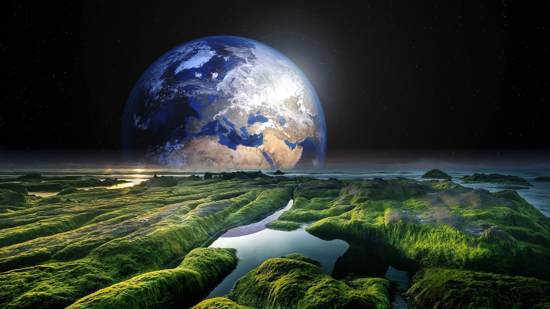 The Earth floating in the night sky with the vast land spread below.